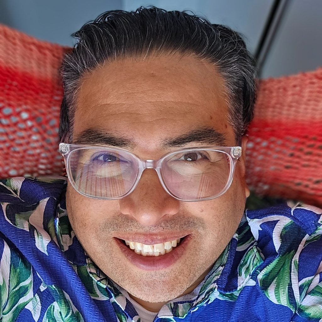 Alan Pinel, founder of VCCP.biz, wearing a blue Hawaiian shirt